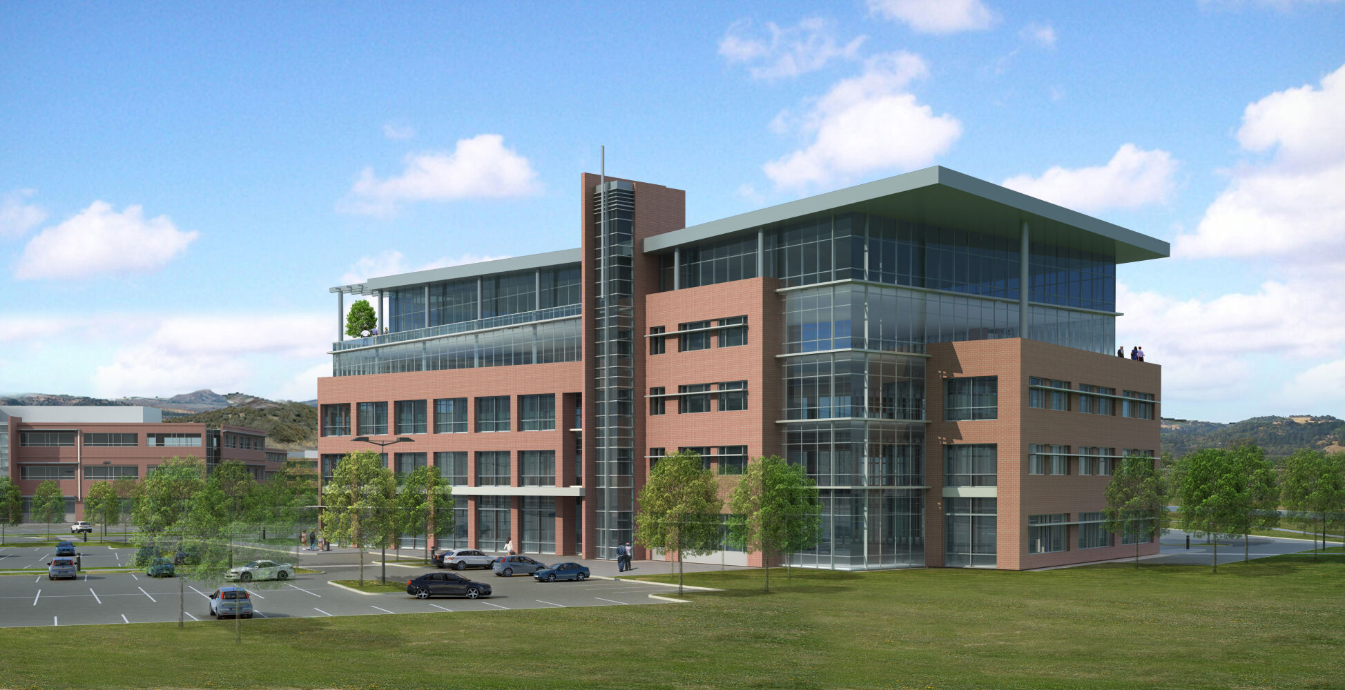 four‑story contemporary office building featuring a brick facade, large glass curtain walls, and landscaped surroundings