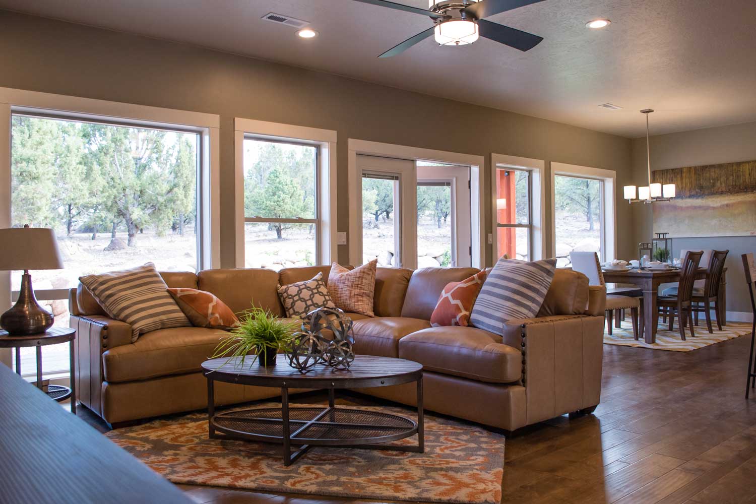 L-shaped soft leather couch with dining room table in the background