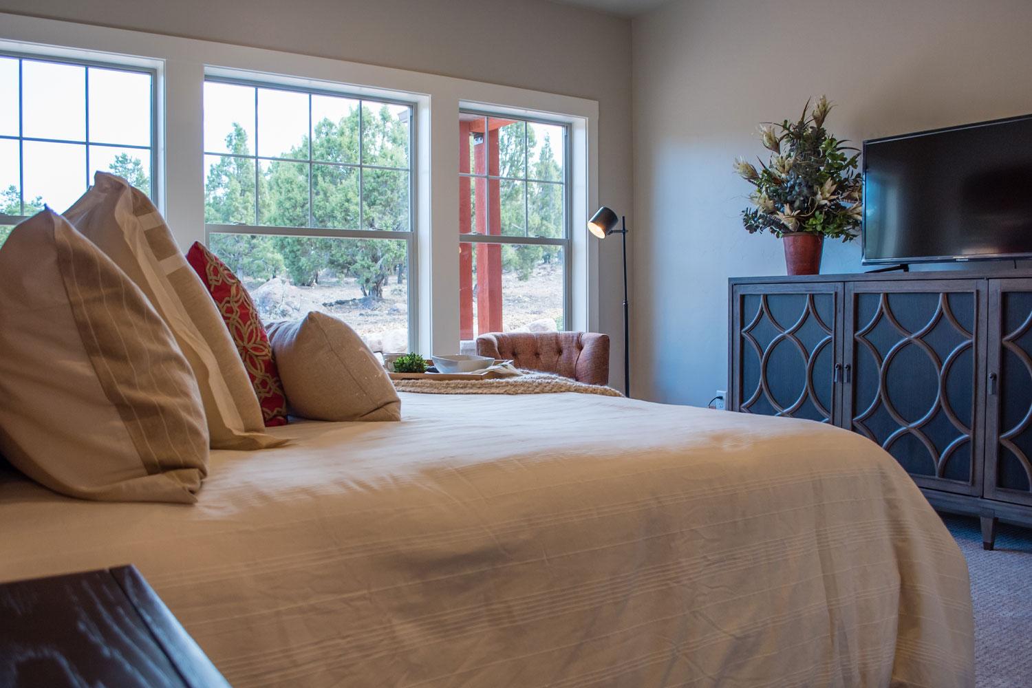 window view from bed in master bedroom looking into backyard