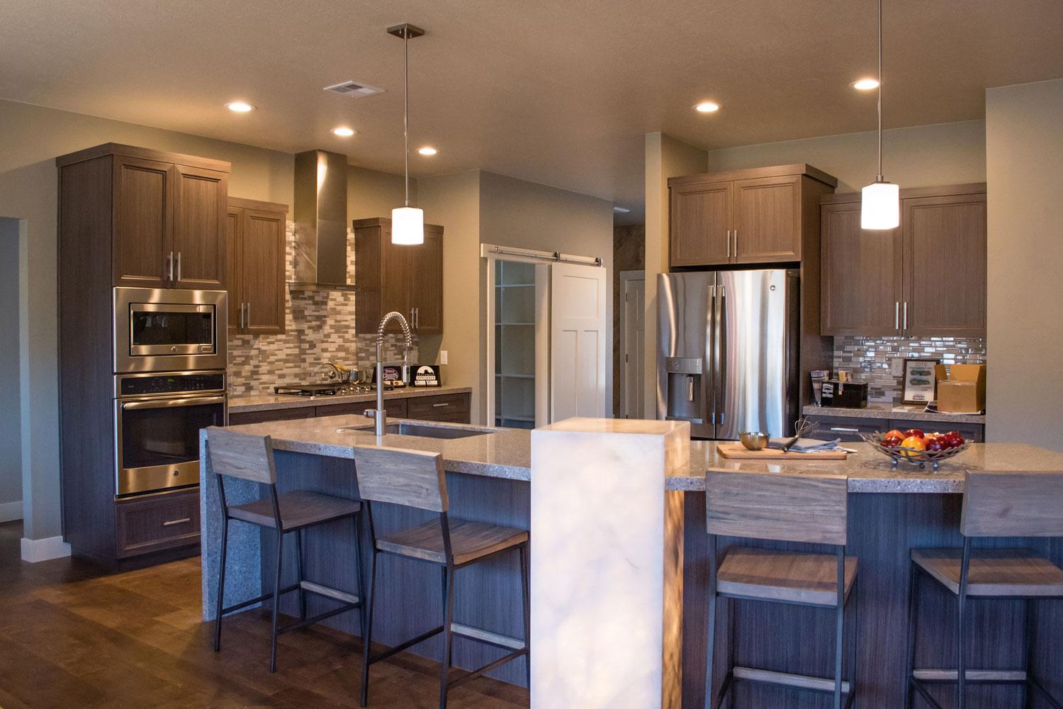 kitchen counter area for dining with four dark brown bar stools 