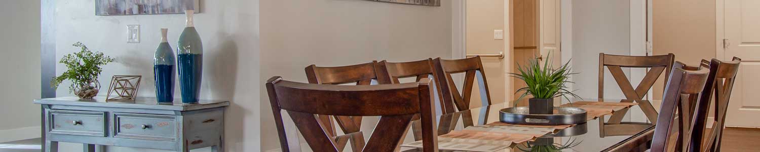 glass top dining room table and eight dark wood chairs