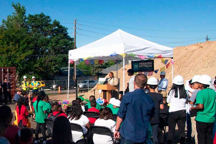 Mayor Hancock speaking from a podium to announce the groundbreaking to a group of students and faculty. 