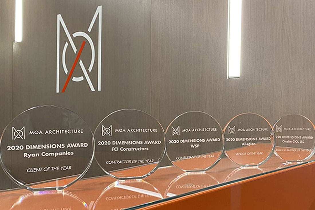 A series of five glass engraved circular awards.