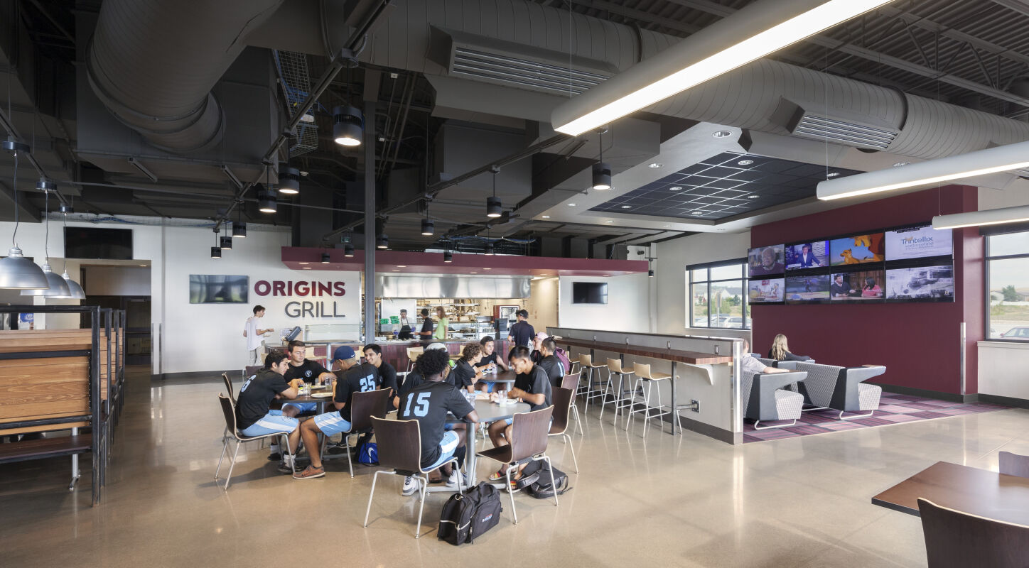 Dining area at Gillette College with food service stations, shared tables, and lounge seating.