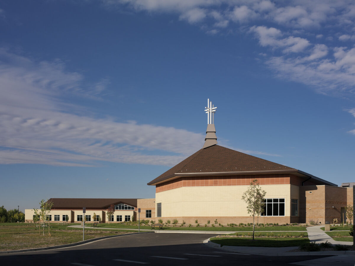 Denver Seminary campus chapel building with a central entrance, light‑colored masonry walls, and a cross‑topped roof.