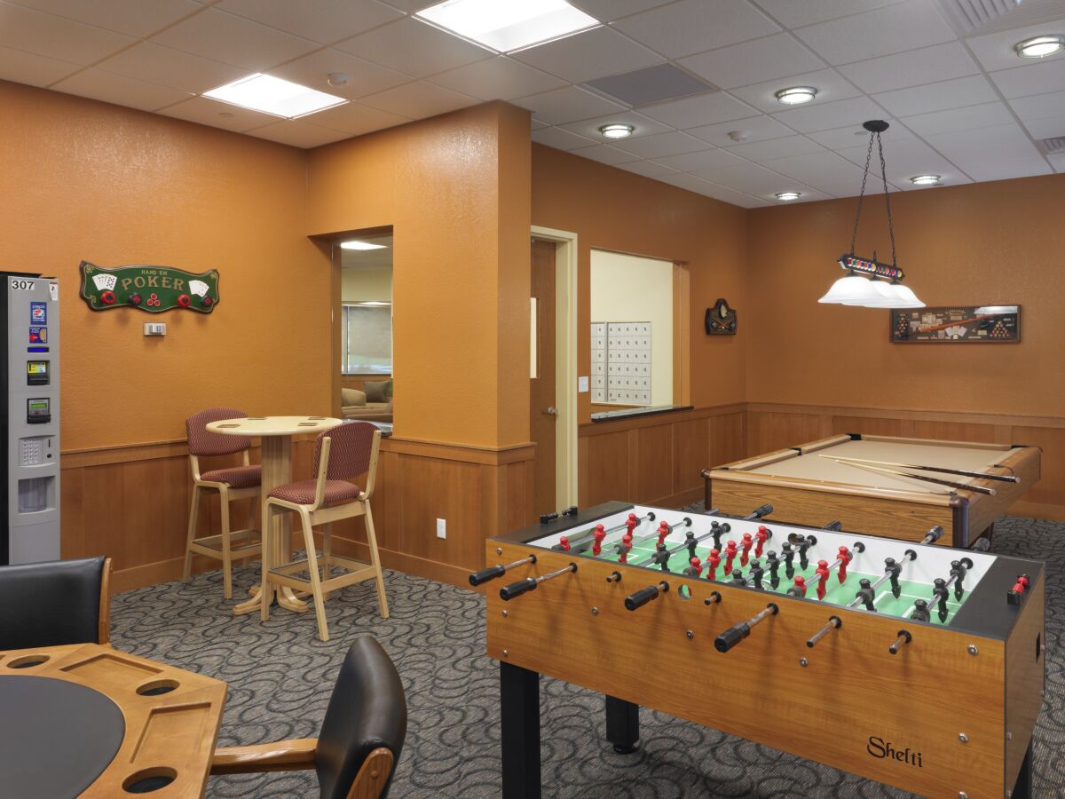 Recreation room at University of Northern Colorado Turner Hall with a pool table, foosball table, high‑top seating, and game room finishes.