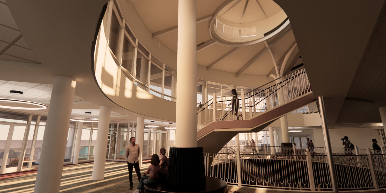 An open atrium with curved balconies, tall columns, a central staircase, and people gathering and moving through the multi‑level space.