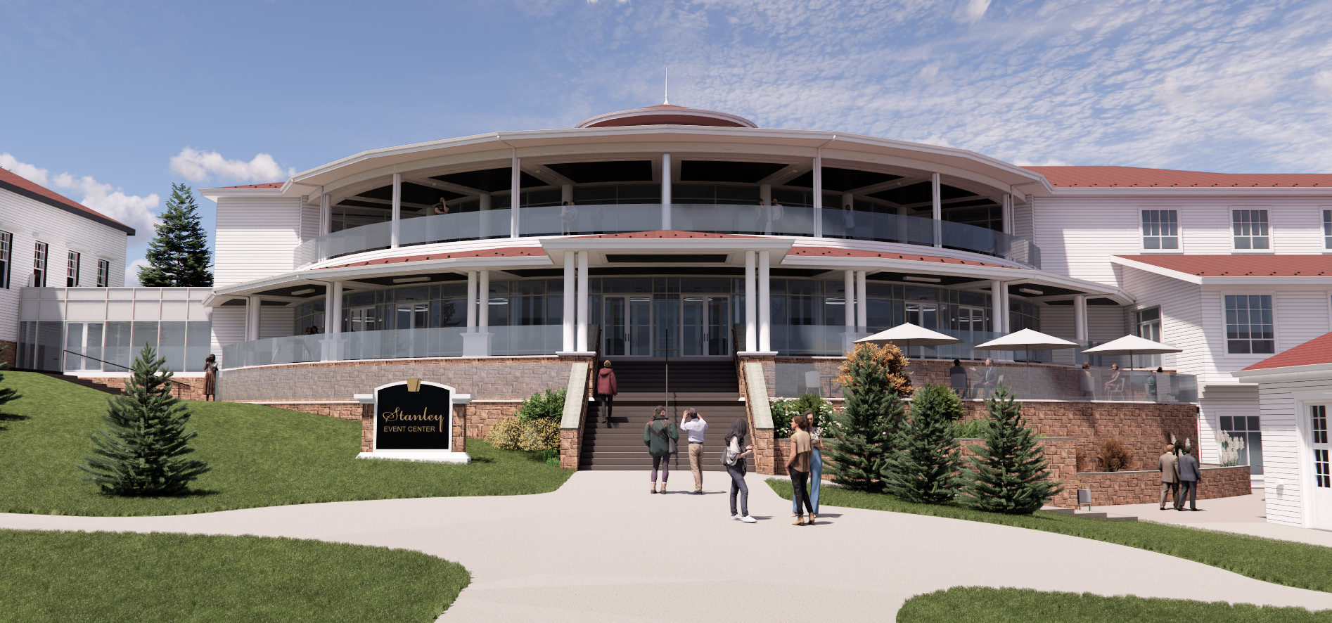 A curved building facade with upper‑level balconies, a central entry reached by wide steps, landscaped lawns, and people approaching the entrance.