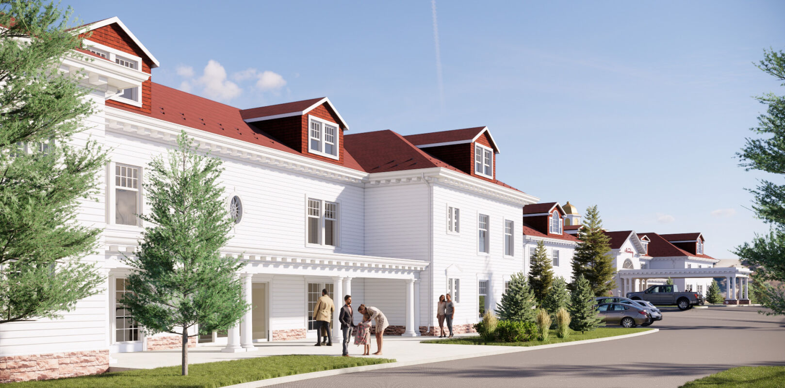 A white lodge building with red rooflines, dormer windows, and a covered entry, set along a drive with landscaped trees, walkways, and adjacent parking.