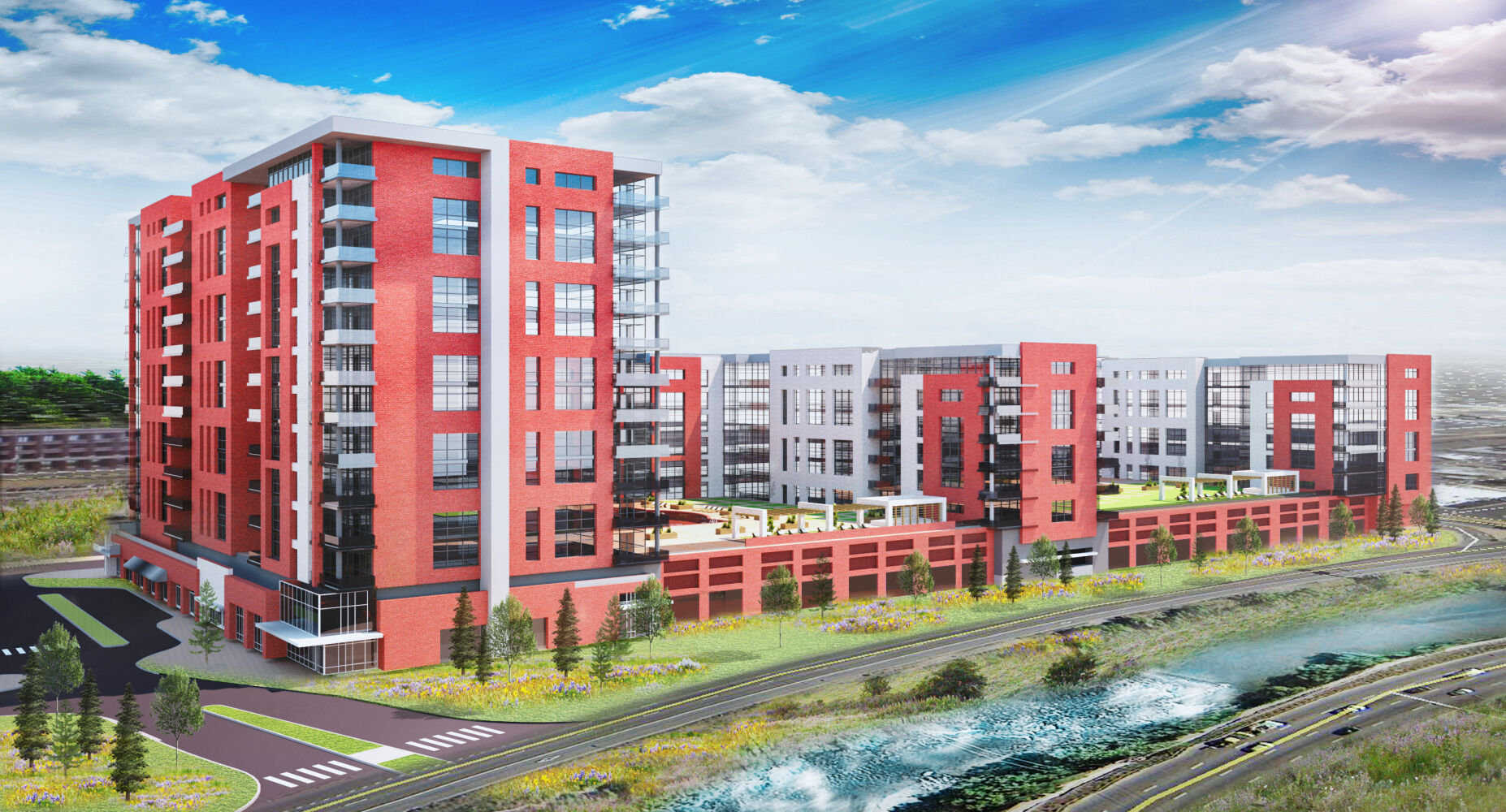 Architectural rendering of a multi‑building residential development featuring red and gray mid‑rise structures, rooftop amenity terraces, landscaped walkways, and an adjacent roadway running alongside a river.