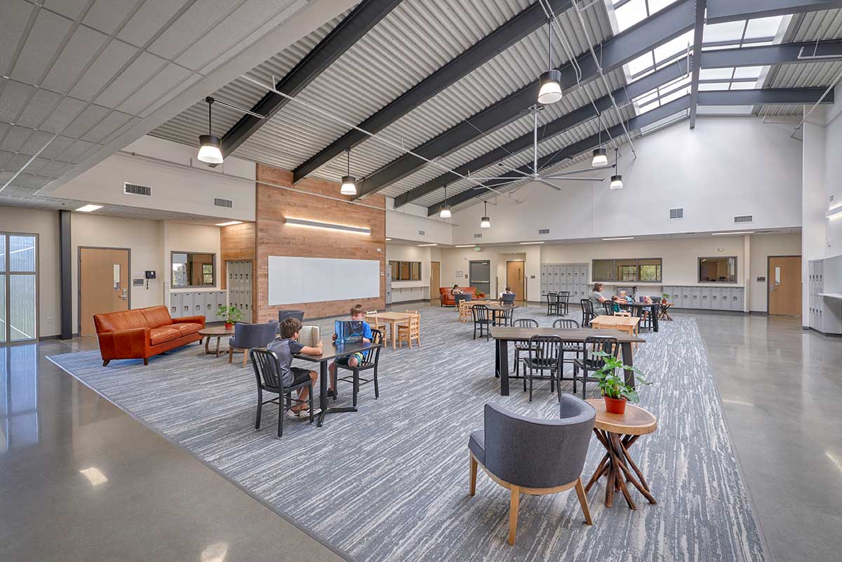 School interior hallway with lockers and classroom entrances.
