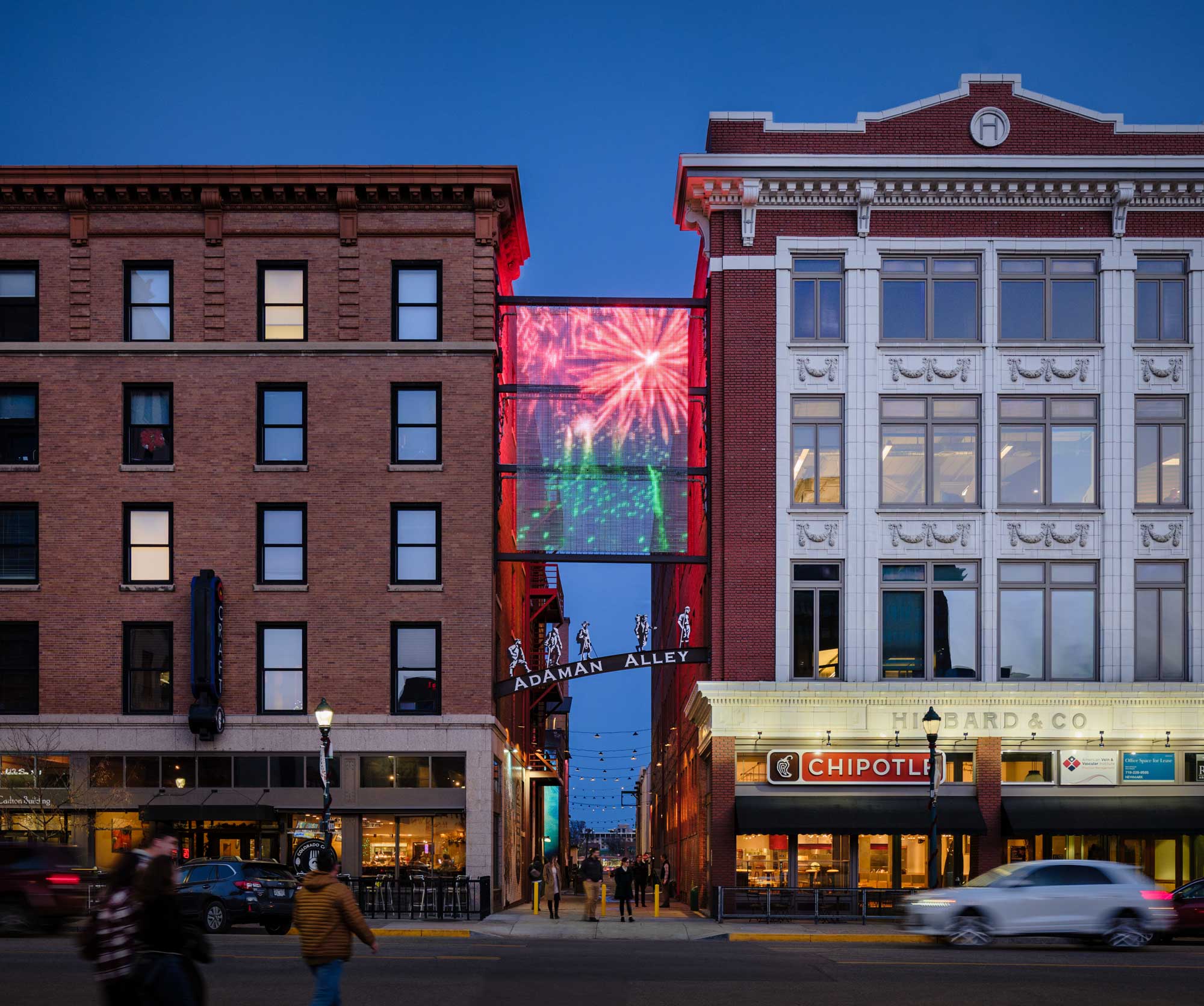 Exterior view of Adaman Alley, featuring a modern urban design with a blend of brick and metal materials. The alleyway is well-lit and designed as a functional pedestrian space, integrating contemporary architectural elements with historical influences.