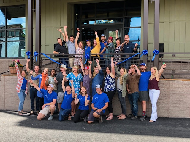 a crowd celebrates in front of the new adaptive sports building