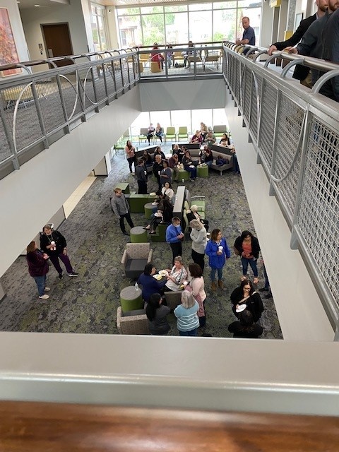 community members gathered in the new east side clinic lobby and second floor for the ribbon cutting