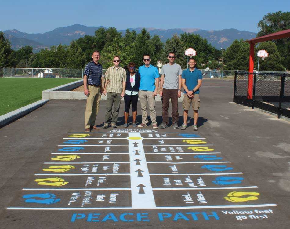 team standing behind the completed peace path